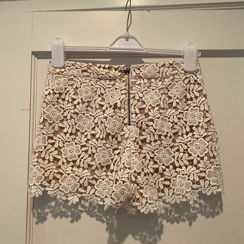 Alice and Olivia nude and white lace shorts.